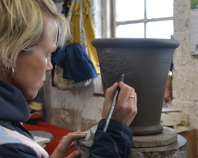 Emma decorating a flowerpot