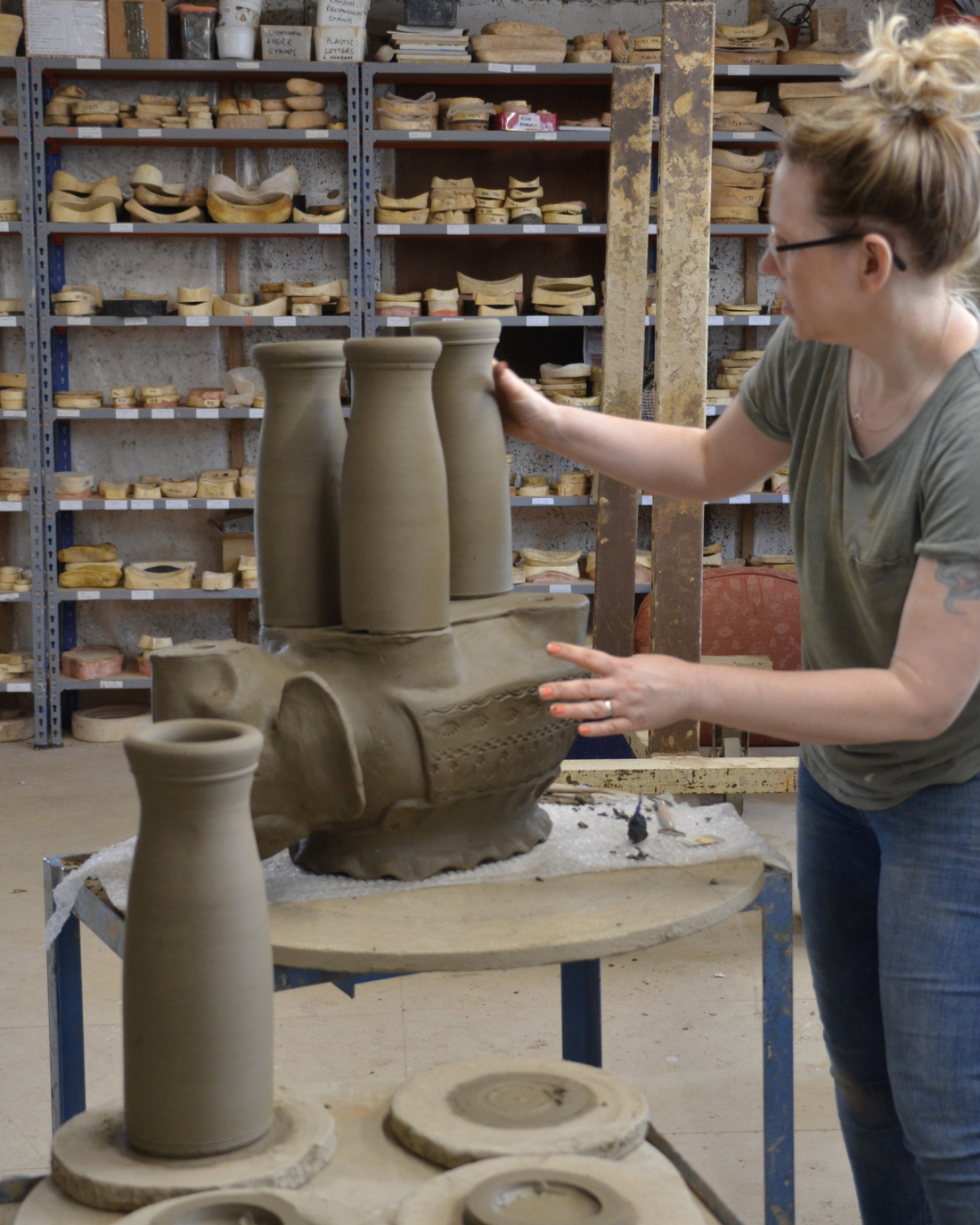 Rachel putting legs on an Elephant Planter Whichford Pottery